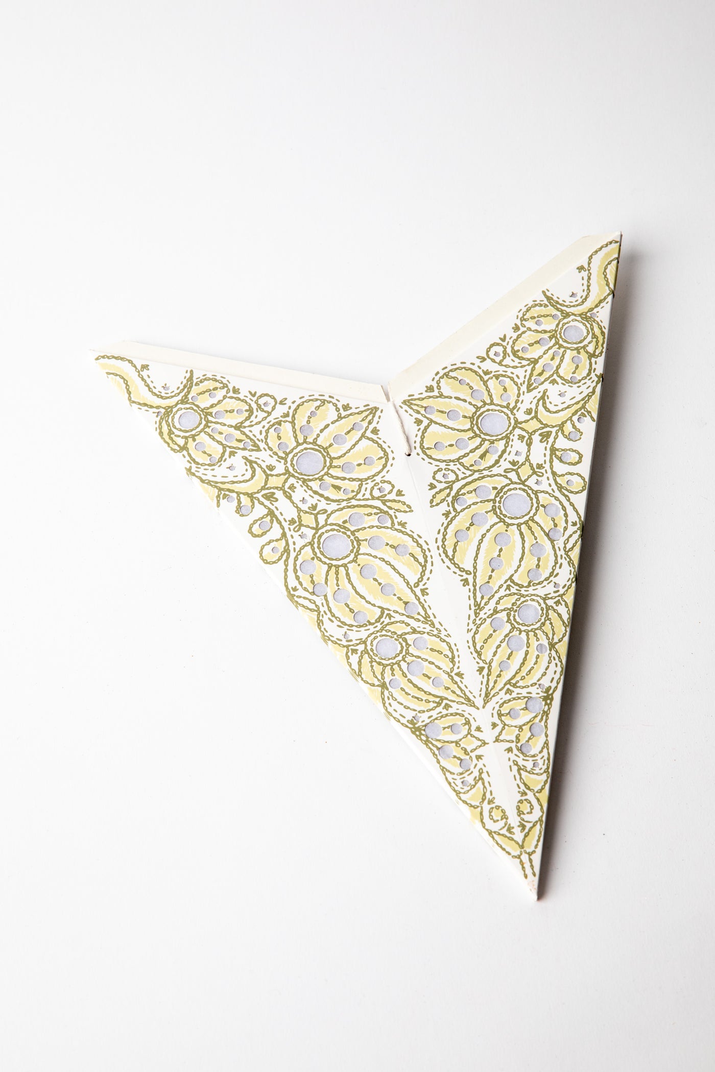 Mari White embroidered paper star folded up, out of the package