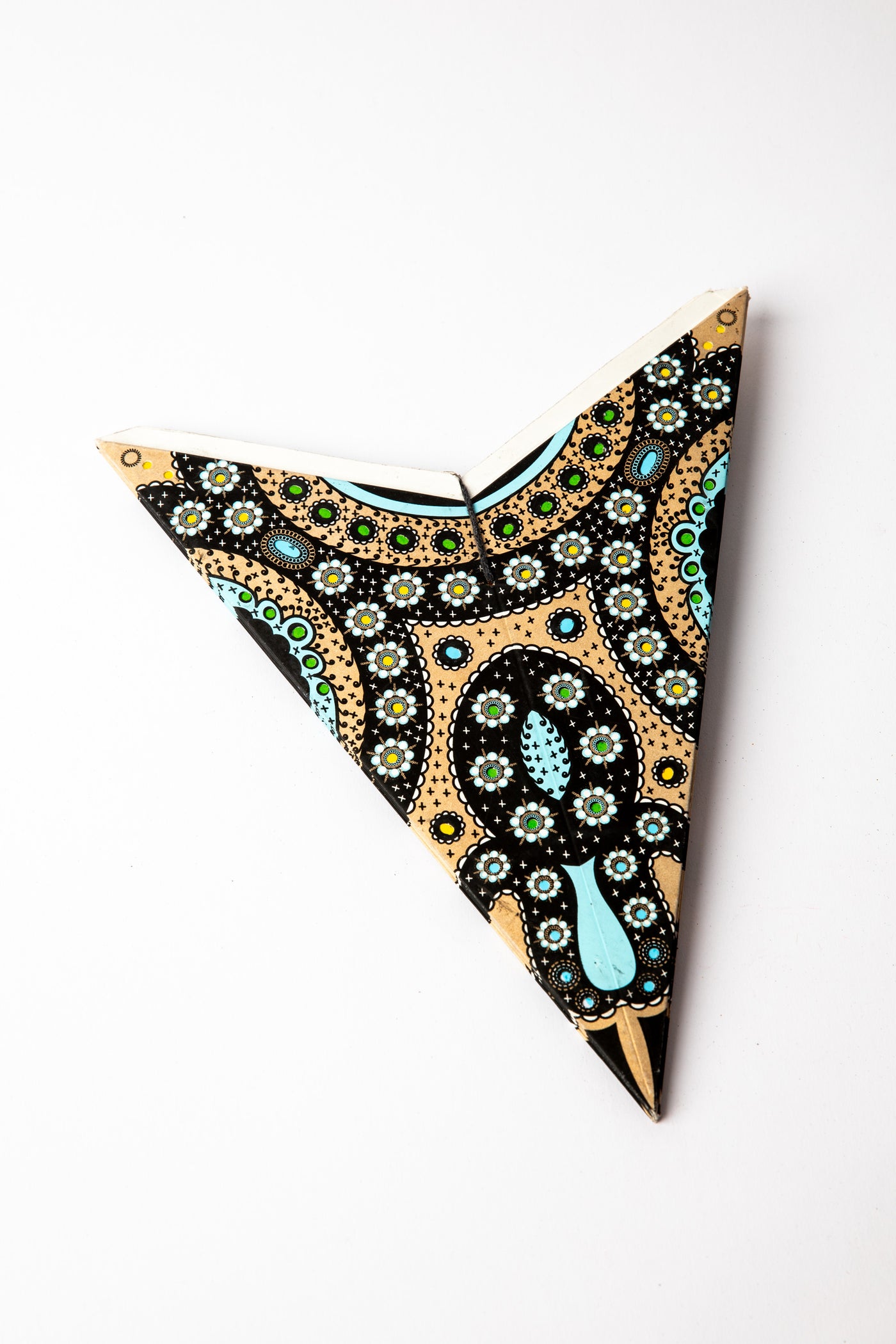 Rajasthani Black Gold embroidered paper star folded up, out of the package