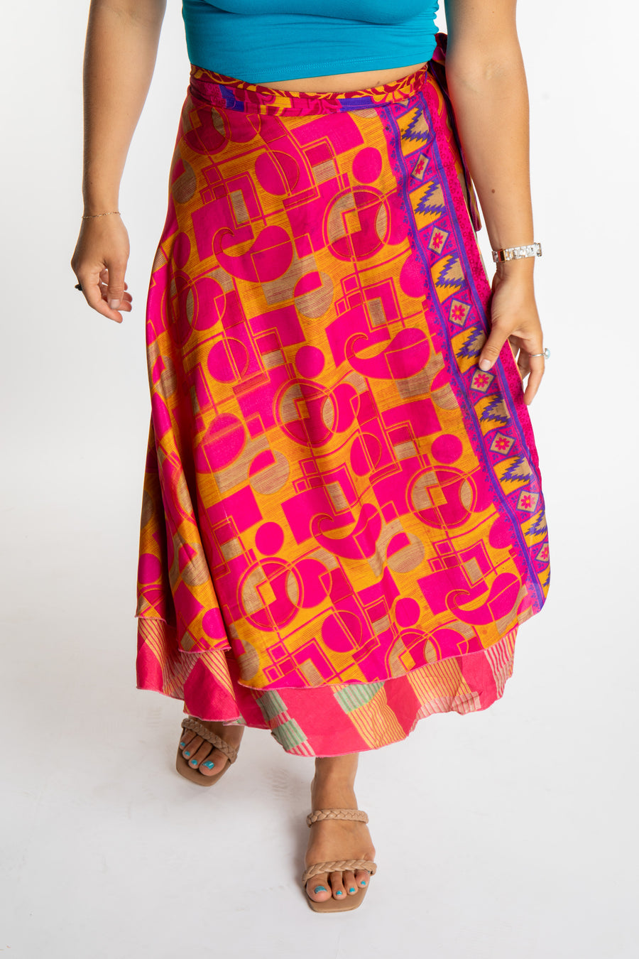 Sophie is wearing a long reversible silk wrap skirt in sugar magnolia