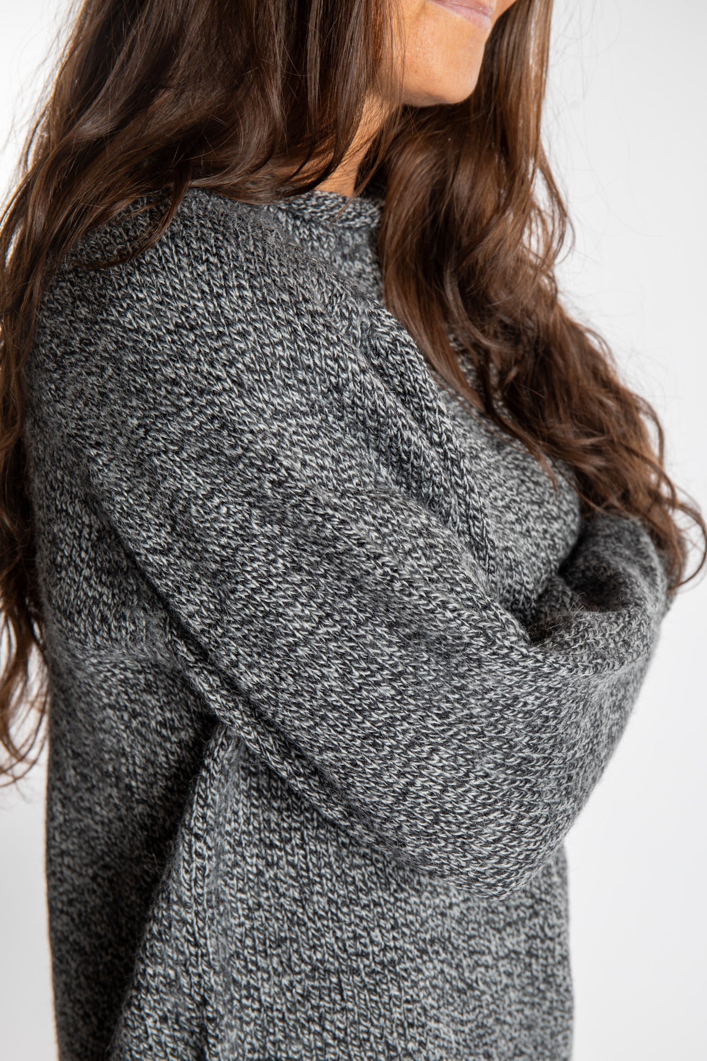 Jen wearing a size large black and white fisherman style sweater 