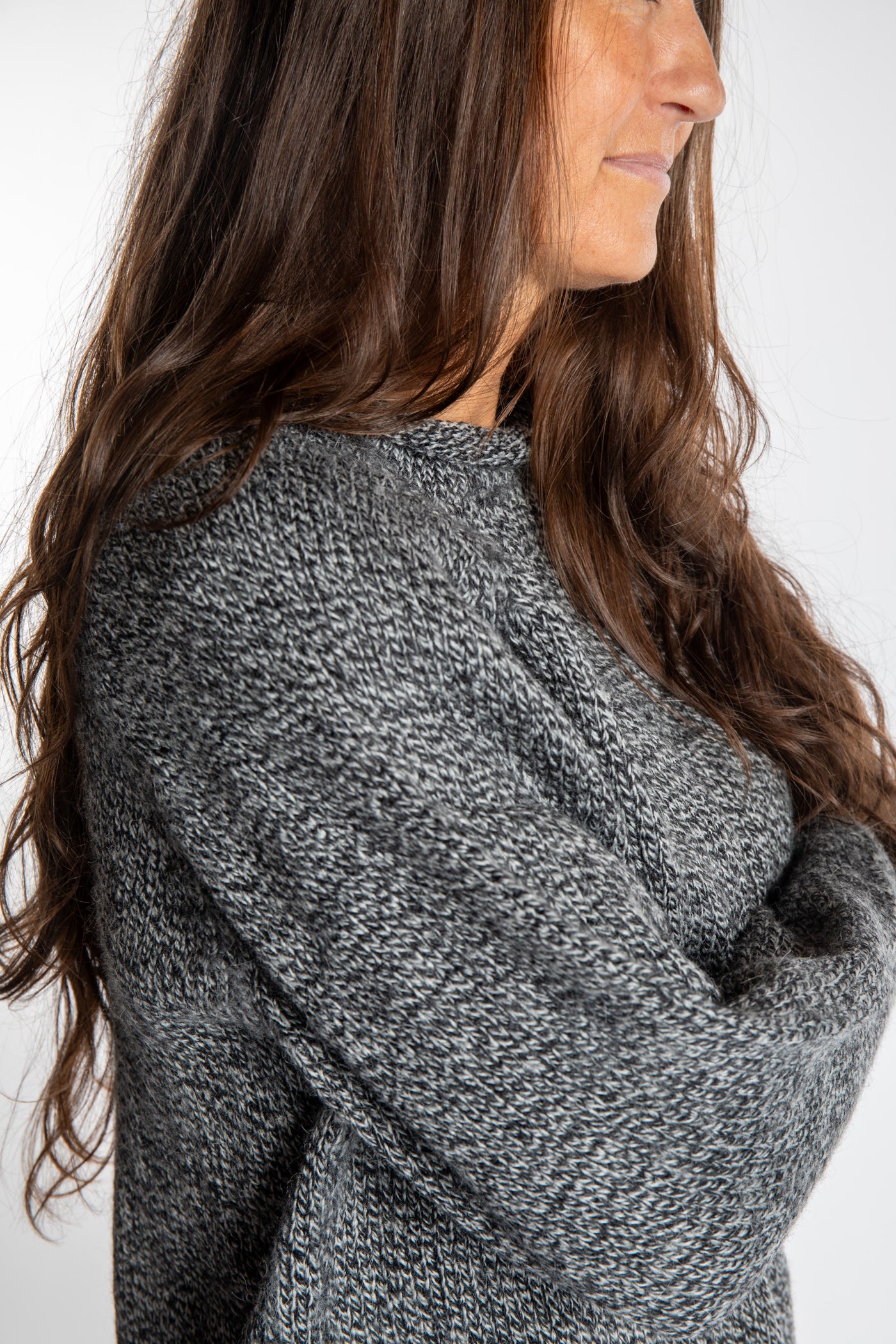 Jen wearing a size large black and white fisherman style sweater 