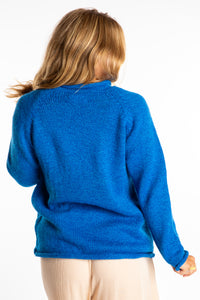 Sophie wearing a size Medium Blueberry fisherman style sweater 