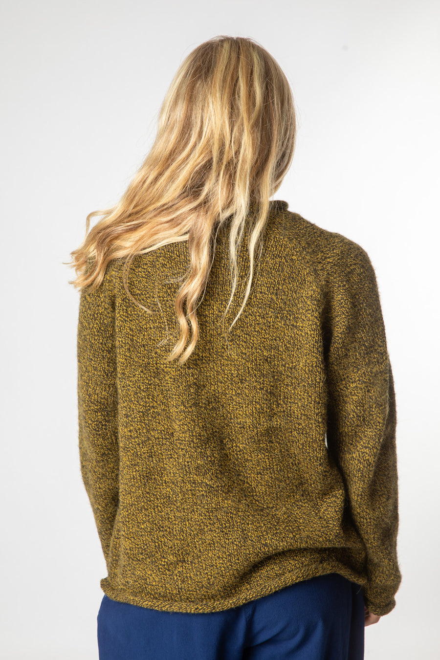 Sophie is wearing size S roll neck alpaca sweater in bumblebee