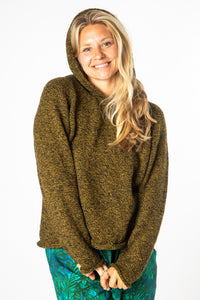 Sophie, wearing size Medium, smiling and wearing a Bumblebee alpaca wool sweater with a hood.