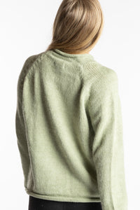 Sophie is wearing the Celery green Classic Unisex Alpaca Wool Sweater in size S