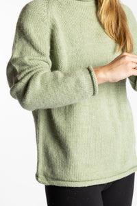 Sophie is wearing the Celery green Classic Unisex Alpaca Wool Sweater in size S