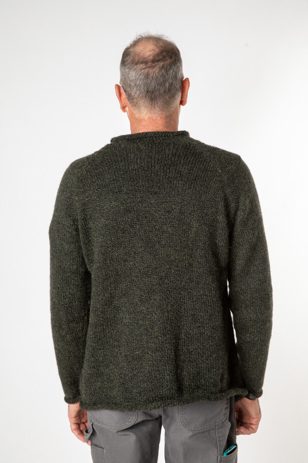 Ross is wearing size L roll neck alpaca sweater in dark green