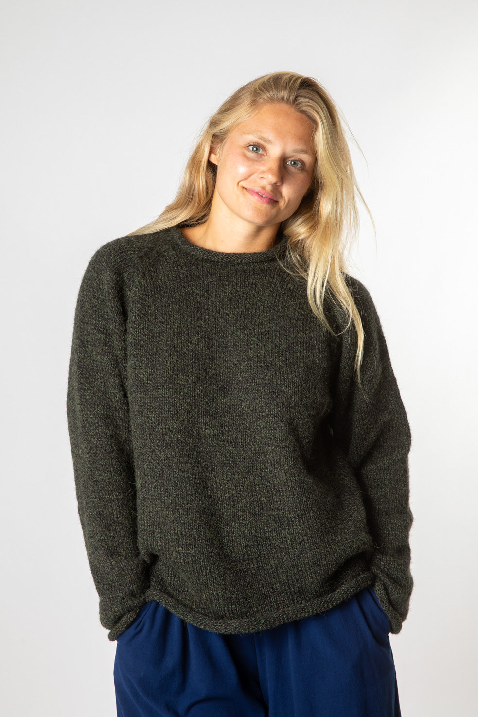 Sophie is wearing size S roll neck alpaca sweater in dark green
