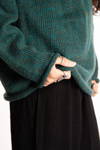 Jen wearing a size large Emerald fisherman style sweater 