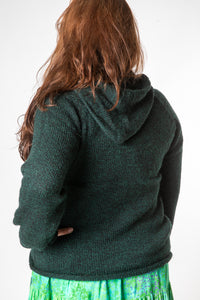 Nicole is wearing size XL alpaca hoodie in forest