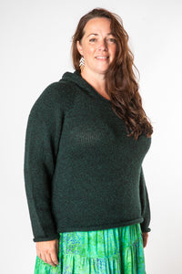 Nicole is wearing size XL alpaca hoodie in forest