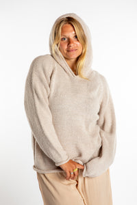 Sophie is wearing size M alpaca hoodie in Oatmeal