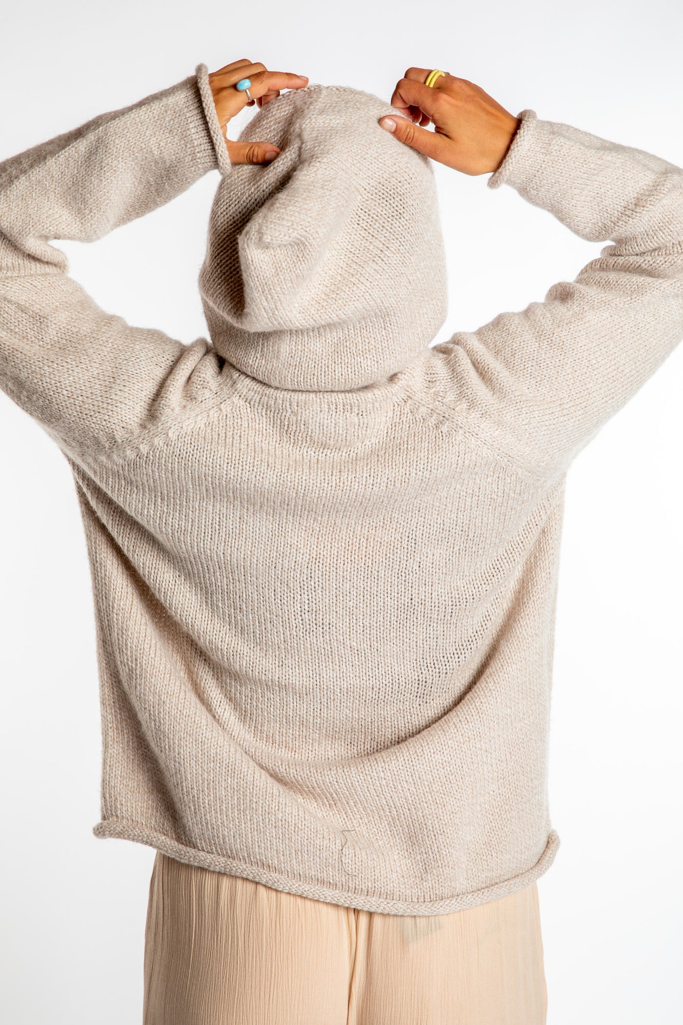 Sophie is wearing size M alpaca hoodie in Oatmeal