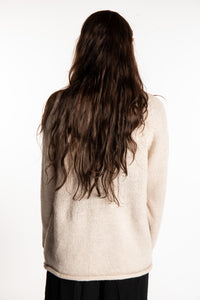 Jen wearing a size large oatmeal fisherman style sweater 