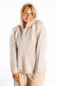 Sophie is wearing size M alpaca hoodie in Oatmeal