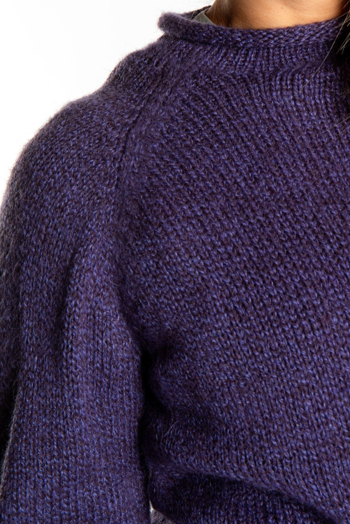 detail of purple roll neck fisherman sweater