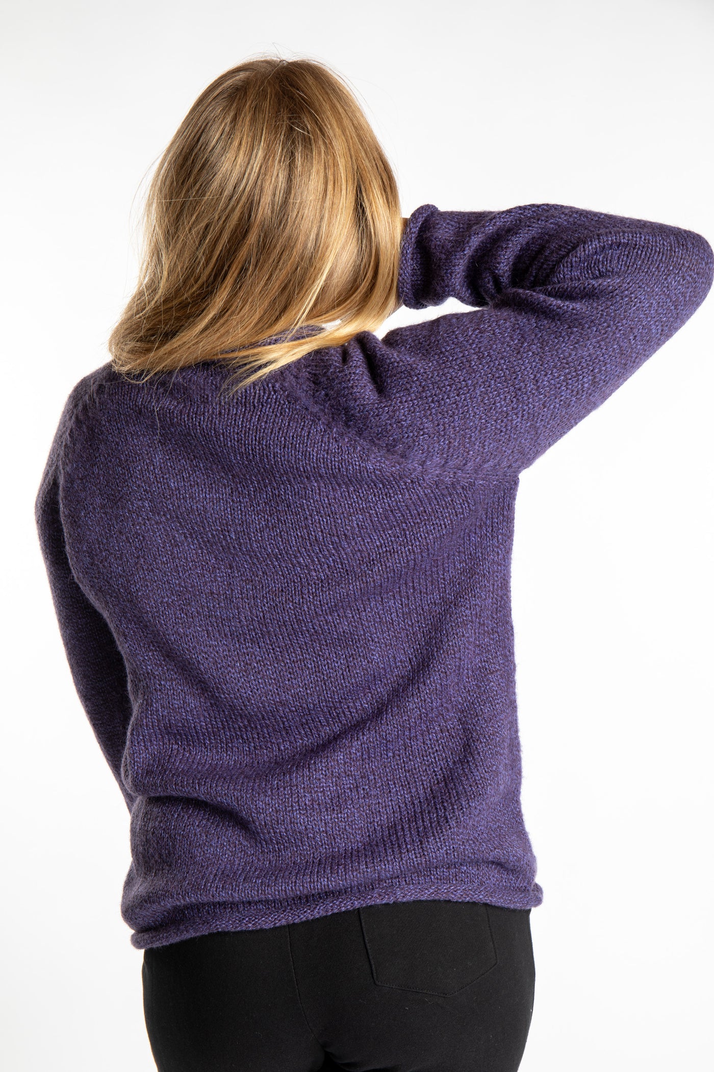 Sophie is wearing size S roll neck alpaca sweater in purple
