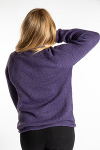 Sophie is wearing size S roll neck alpaca sweater in purple