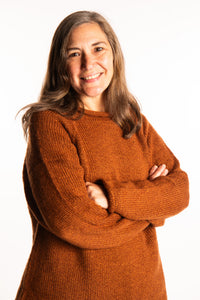 Holly wearing a size Large Rust fisherman style sweater 