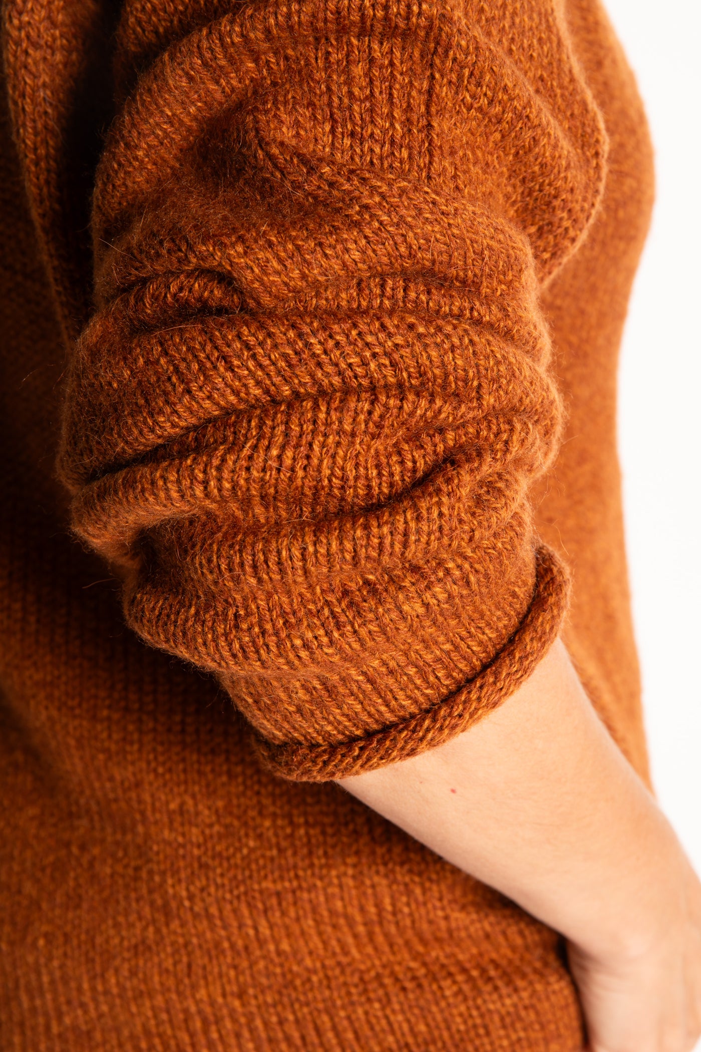 Holly wearing a size Large Rust fisherman style sweater 