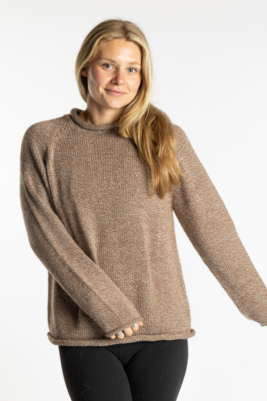 Sophie is wearing the Tan Classic Unisex Alpaca Wool Sweater in size S
