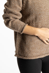 Sophie is wearing the Tan Classic Unisex Alpaca Wool Sweater in size S