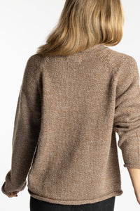 Sophie is wearing the Tan Classic Unisex Alpaca Wool Sweater in size S