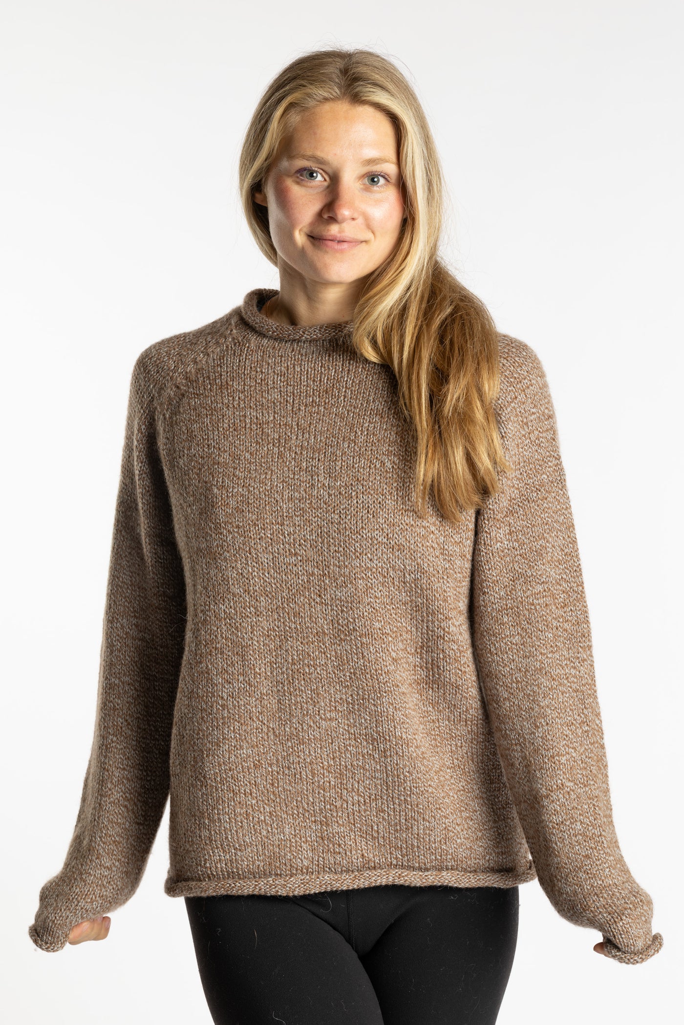 Sophie is wearing the Tan Classic Unisex Alpaca Wool Sweater in size S