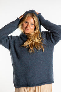Sophie is wearing a size M hooded alpaca sweater in Vintage Denim blue