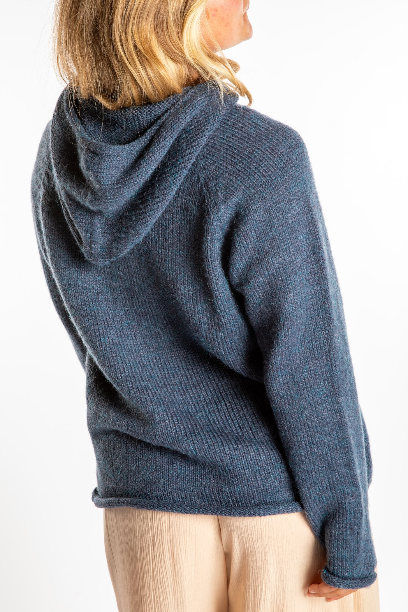 Sophie is wearing a size M hooded alpaca sweater in Vintage Denim blue