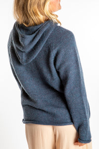 Sophie is wearing a size M hooded alpaca sweater in Vintage Denim blue