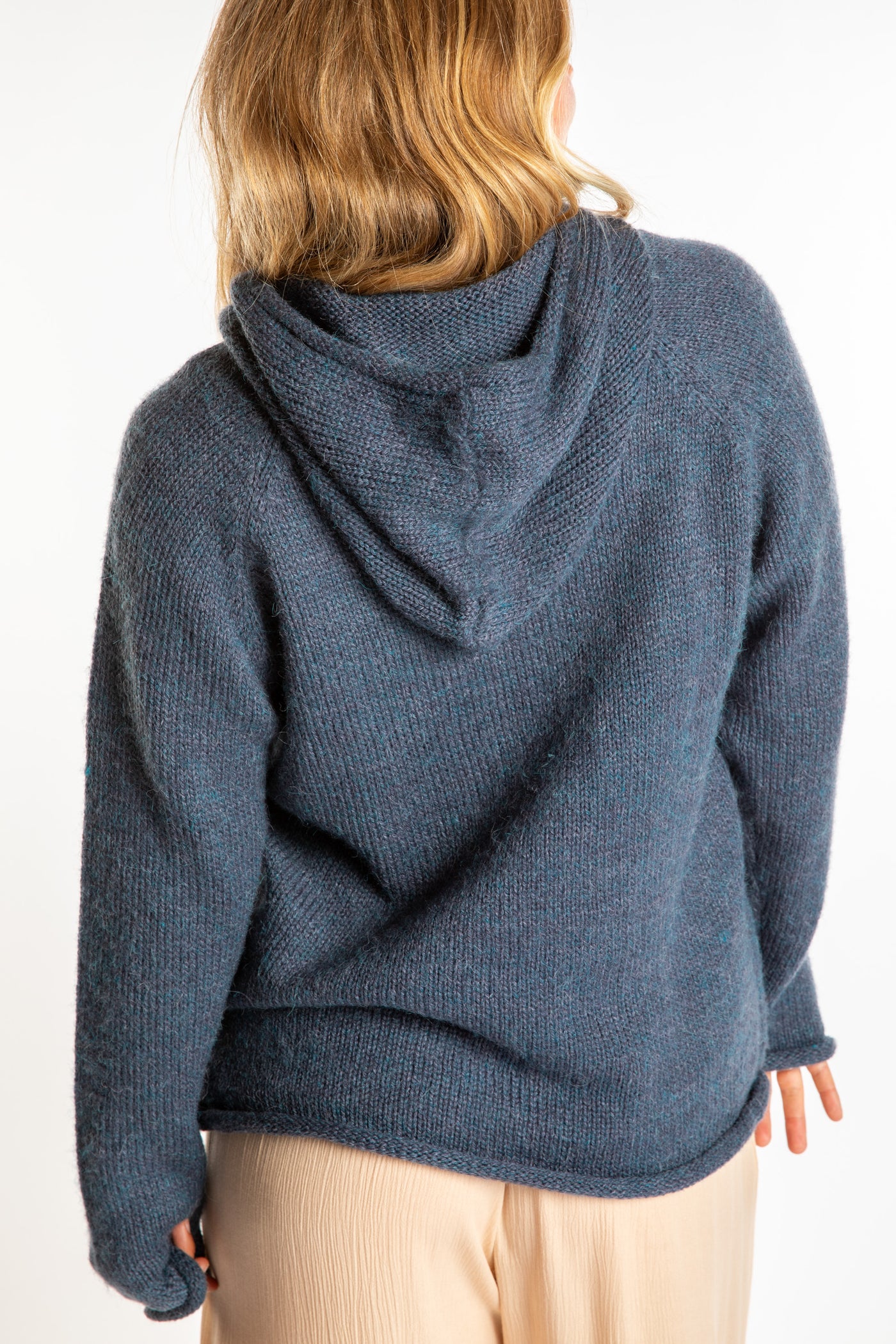 Sophie is wearing a size M hooded alpaca sweater in Vintage Denim blue