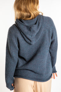 Sophie is wearing a size M hooded alpaca sweater in Vintage Denim blue