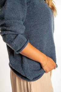 Sophie is wearing a size M hooded alpaca sweater in Vintage Denim blue