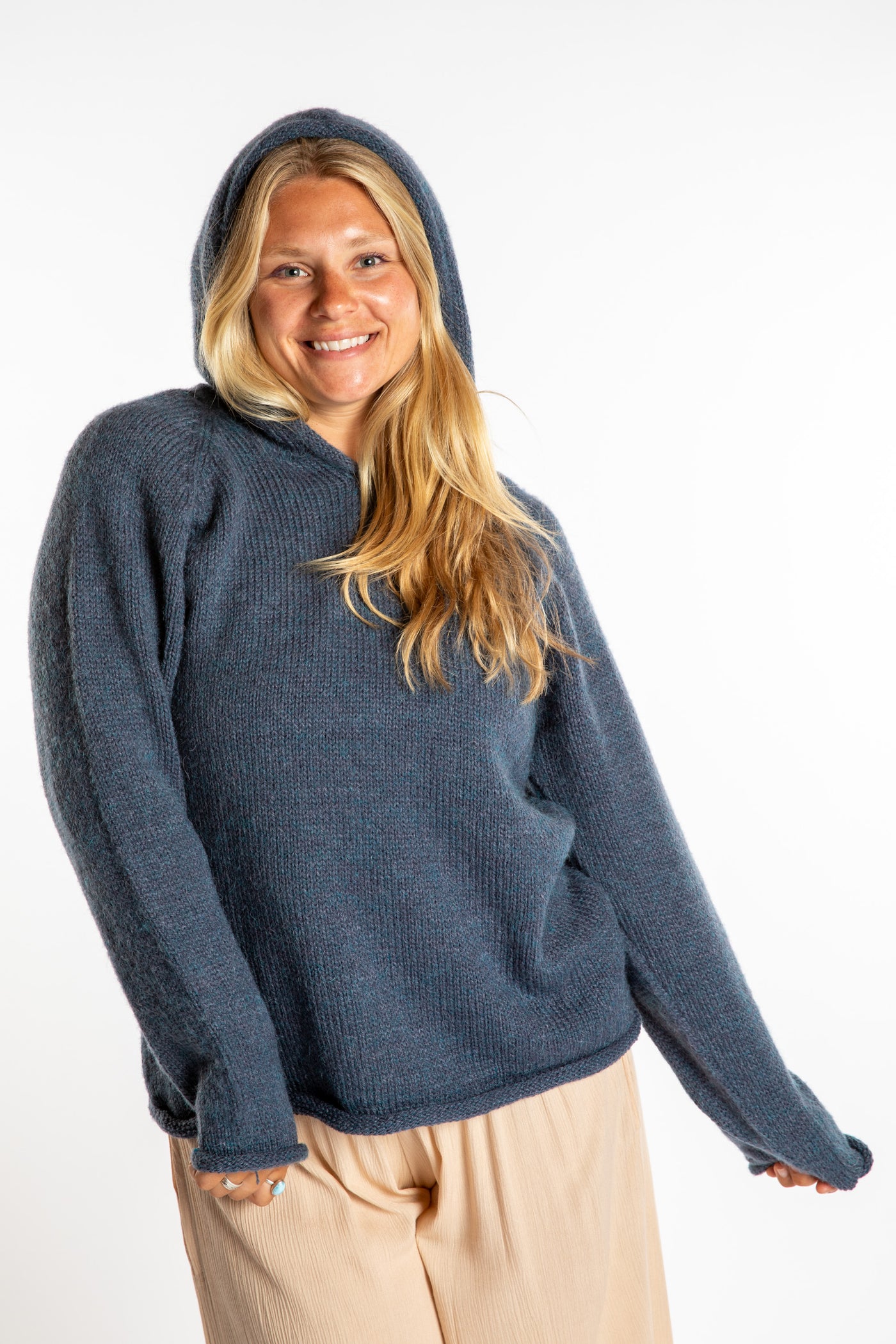 Sophie is wearing a size M hooded alpaca sweater in Vintage Denim blue