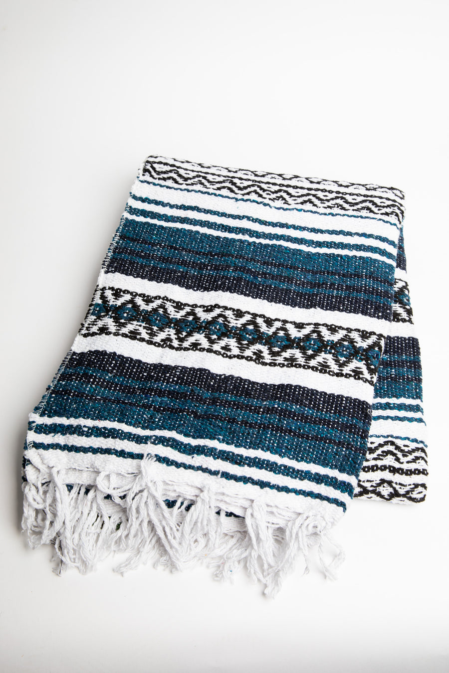 Woven recycled blanket with blue, white, and black pattern on a white background