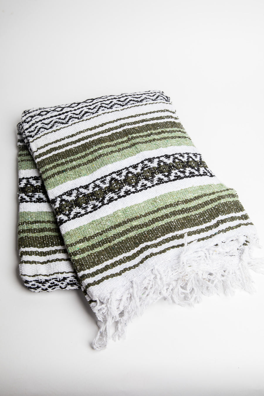 Striped recycled blanket with green, white, and black pattern on a white background