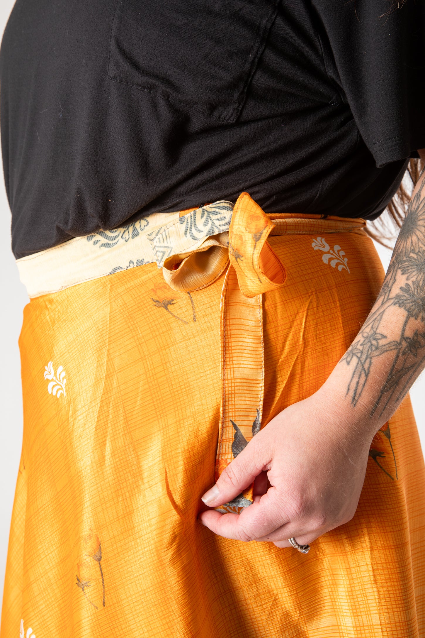 Desiree is wearing a silk wrap skirt in fire on the mountain