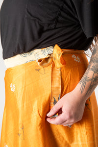 Desiree is wearing a silk wrap skirt in fire on the mountain