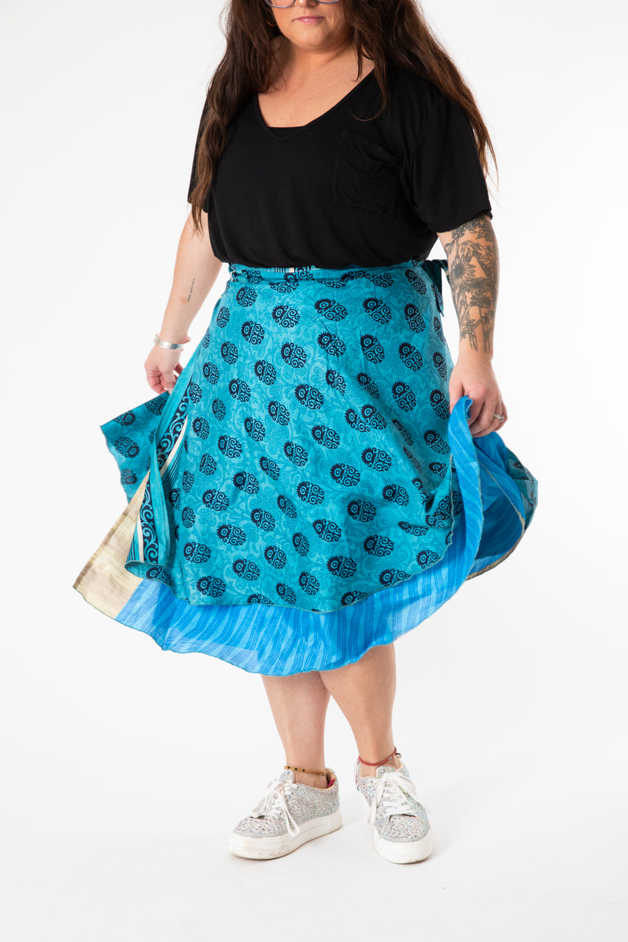 Desiree is wearing a silk wrap skirt in morning dew