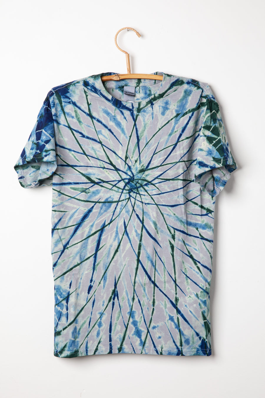 Tie-dye Charcoal with indigo and hunter colored t-shirt with a spiral pattern on a white background