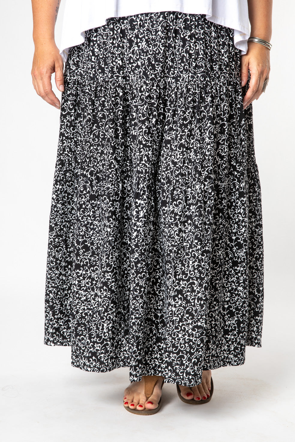 Nicole is wearing size M/L batik prairie skirt in black and white tendrils