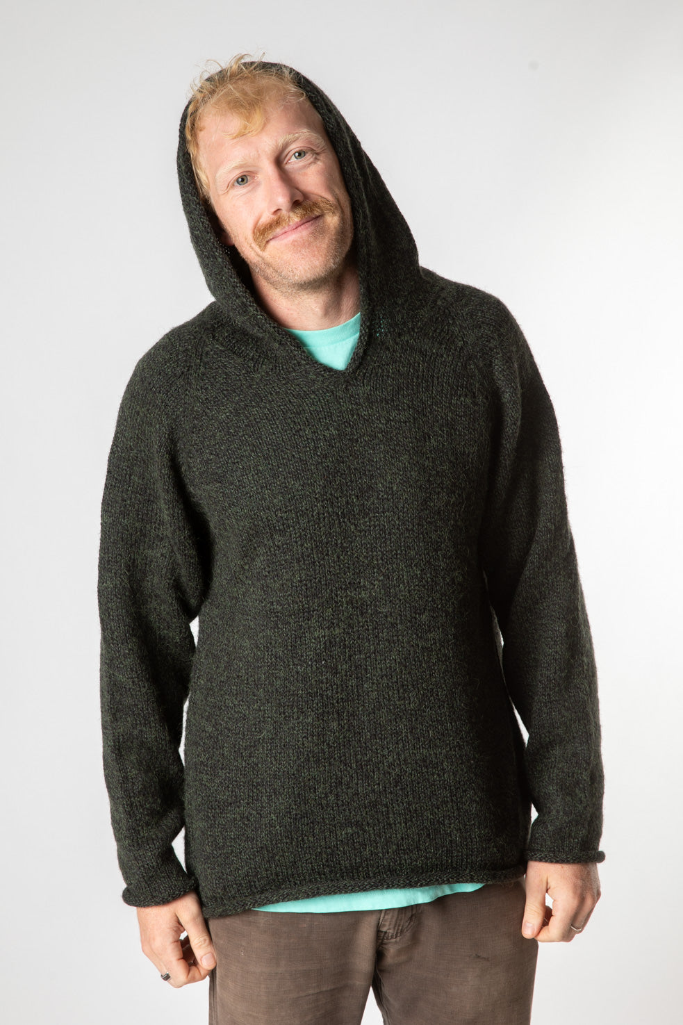 Chauncey is wearing size L alpaca hoodie in dark green