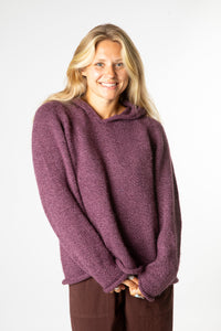 Sophie is wearing size M alpaca hoodie in plum