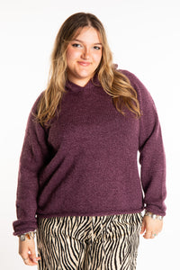 Emma is wearing a size L hooded alpaca sweater in Plum