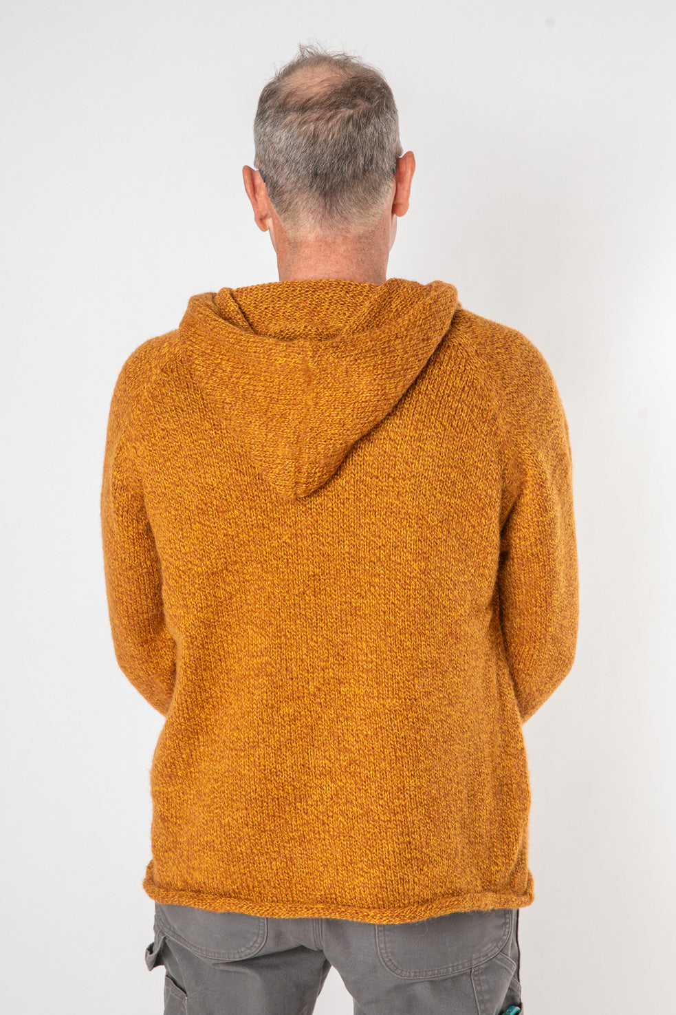 Ross is wearing size L alpaca hoodie in sunflower