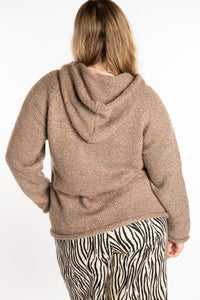 Emma is wearing a size L hooded alpaca sweater in Tan
