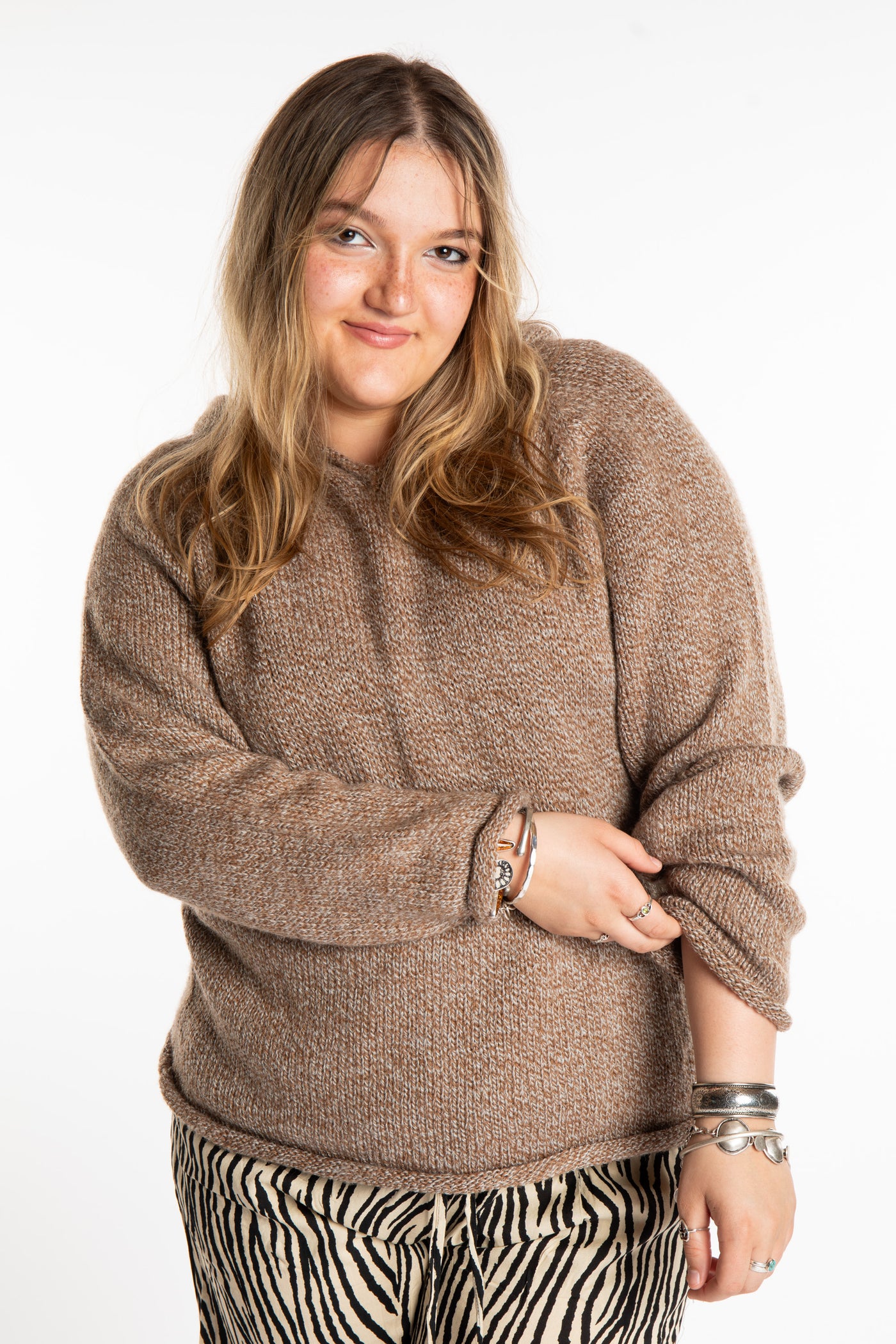 Emma is wearing a size L hooded alpaca sweater in Tan
