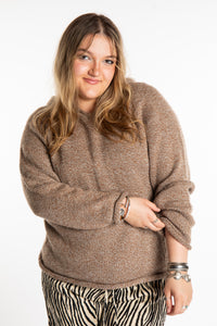 Emma is wearing a size L hooded alpaca sweater in Tan
