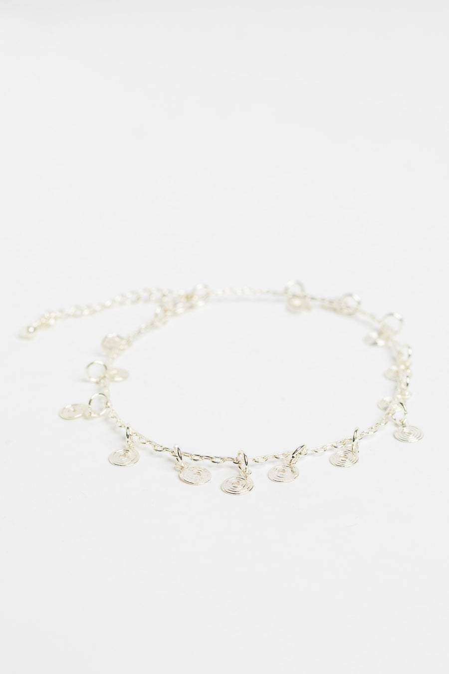 silver spiral charm anklet on white background
